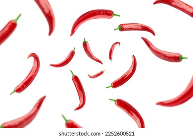 Falling red hot chili peppers isolated on white background, selective focus