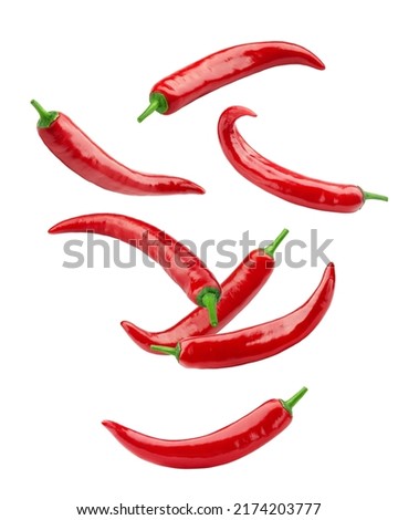 Falling red hot chili peppers isolated on white background, clipping path