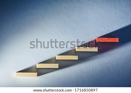 Falling and reduction. Growing and increasing. Business rise or fall. Wooden blocks in ascending order. Copy space