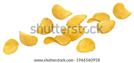Falling ridged potato chips isolated on white background with clipping path