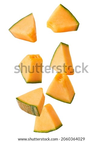 Falling slices of cantaloupe melon isolated on white background.