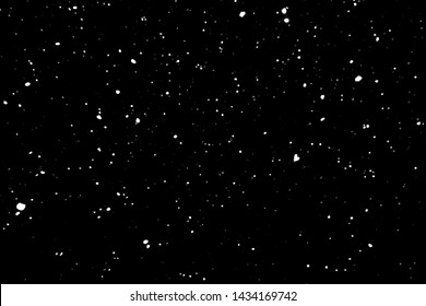 falling snow on a black background. snowfall at night. white spots on a black background