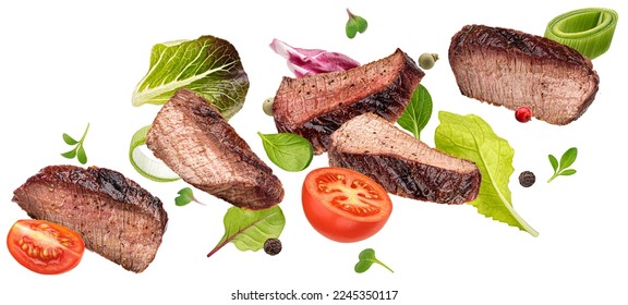 Falling steak salad ingredients isolated on white background, sliced beefsteak, food packaging concept - Shutterstock ID 2245350117