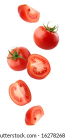 Falling Tomatoes Isolated On A White Background With A Clipping Path. Whole Red Tomatoes And Cut Pieces Fly In The Air. Vegetables Fall Down.