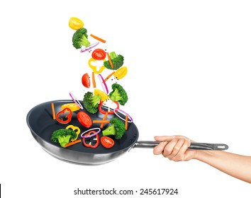 Falling Vegetables In Frying Pan On An Isolated White Background