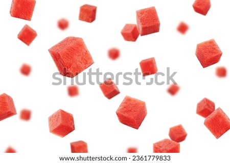 Falling Watermelon cubes isolated on white background, selective focus