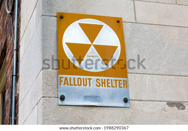 Fallout Shelter sign\
informs about nearby enclosed space specially designated to protect\
occupants from radioactive debris or fallout resulting from a\
nuclear explosion