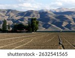 Fallow field with dramaticly bare desert San Emigdio Mountains in the San Joaquin Valley, California. 2014