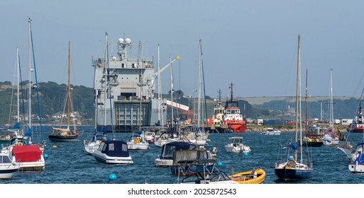 Falmouth, Cornwall, England, UK. 2021.  RFA vessel Cardigan Bay a Bay Class dock ship undergoing a refit in Falmouth Harbour surrounded by pleasure craft, cruisers, ferries and small boats.