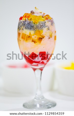 Falooda, a popular cold dessert of the Indian subcontinent. Falooda is mixed with rose syrup, vermicelli, sweet basil seeds, pieces of jelly with milk and topped off with a scoop of ice cream.
