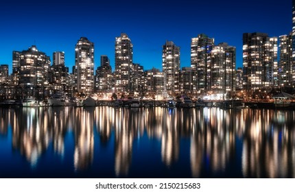 False Creek With Modern City Buildings At Night After Sunset. Downtown Vancouver Cityscape, British Columbia, Canada. Panorama