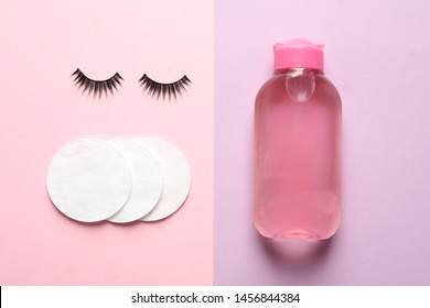 False Eyelashes, Cotton Pads And Makeup Remover On Color Background, Flat Lay