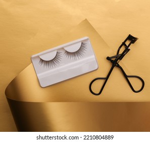 False Eyelashes With Lash Curler On A Luxurious Golden Background