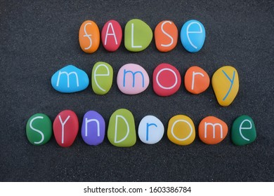 False Memory Syndrome Text Composed With Creative Painted Stone Letters Over Black Volcanic Sand