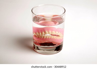 False Teeth In A Glass Of Water