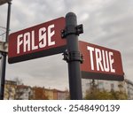 False and True: Dual Red Signs Depicting the Timeless Conflict Between Deception and Truth, Reflecting Life’s Struggle to Discern Reality from Illusion in a World of Ambiguity and Contrasts.