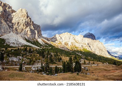The Falzarego pass. Mountain range in the Eastern Alps. The clouds are flying across the sky. Sunset in the colorful rocks of the Dolomites. 