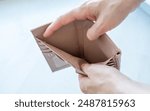 Famale hand open an empty wallet on white background