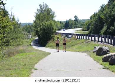 Families and couples enjoying the summer in Northern Michigan along the Little Traverse Wheelway,  a picturesque paved trail running parallel to the Route 31.  - Shutterstock ID 2191323175