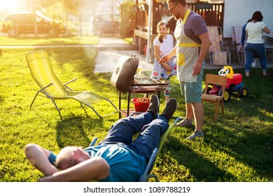 Familly Grilling And Having A Picnic On A Bright Beautiful Spring Sunny Day.