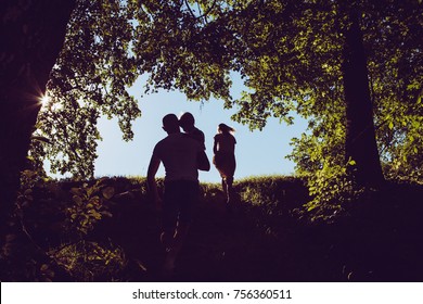 Familly Shadows In Wood. Beautiful Green Trees. 
Sun Rays Through The Trees. Rustic Vintage Style.