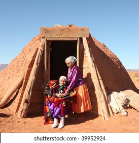 Family Of 2 Navajo Women Outside Their Traditional Hogan Hut