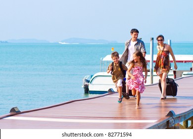 A Family Of 4 Arriving At The Resort With Their Luggage.