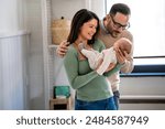 Family, adoption, baby, parenthood and people concept. Happy mother father with newborn baby at home