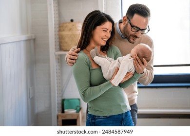 Family, adoption, baby, parenthood and people concept. Happy mother father with newborn baby at home - Powered by Shutterstock