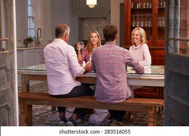 Family With Adult Offspring Enjoying Meal At Home Together