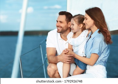 Family Adventure On Yacht. Happy Parents And Kid Yachting Sitting On Deck Looking Aside At Sea Water Enjoying Vacation Outside.