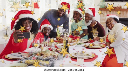 Family of African Americans in Santa hats, celebrating Christmas. Father and son holding smartphone, taking selfie. Sitting around dinner table with festive food, enjoying meal together - Powered by Shutterstock