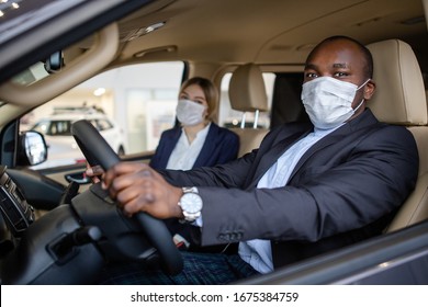 Family An African Man With A European Girl In Medical Protective Masks Emigrate To Another Country While Driving A Minivan