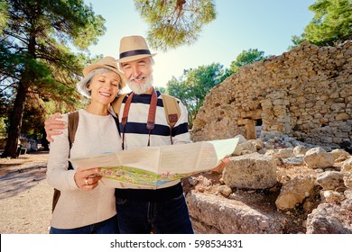 Family, Age, Tourism And Travel Concept. Happy Senior Couple With Map At Ancient Sightseeing.