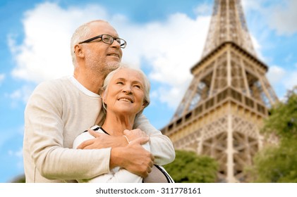 Family, Age, Tourism, Travel And People Concept - Happy Senior Couple Hugging Over Paris Eiffel Tower In France