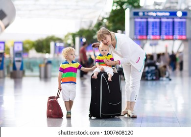 Family At Airport Before Flight. Mother And Kids Waiting To Board At Departure Gate Of Modern International Terminal. Traveling And Flying With Children. Mom With Baby And Toddler Boarding Airplane.