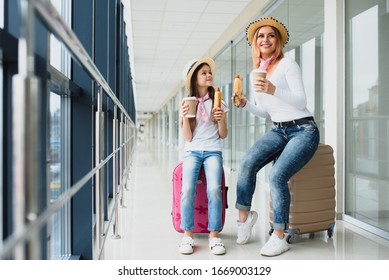 Family At Airport Before Flight. Mother And Kid Waiting To Board At Departure Gate Of Modern International Terminal. Traveling And Flying With Children. Mom With Baby At Boarding Airplane.