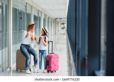 Family At Airport Before Flight. Mother And Kid Waiting To Board At Departure Gate Of Modern International Terminal. Traveling And Flying With Children. Mom With Baby At Boarding Airplane.