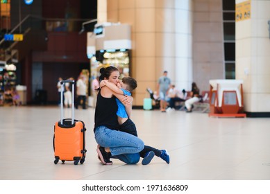 Family At Airport Before Flight. Mother And Son Waiting To Board At Departure Gate Of Modern International Terminal. Traveling And Flying With Children. Mom With Baby And Toddler Boarding Airplane.