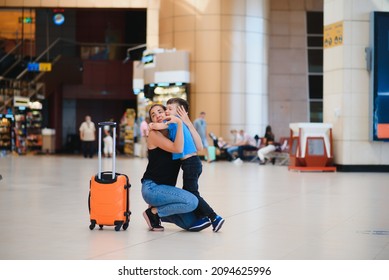 Family At Airport Before Flight. Mother And Son Waiting To Board At Departure Gate Of Modern International Terminal. Traveling And Flying With Children. Mom With Baby And Toddler Boarding Airplane.