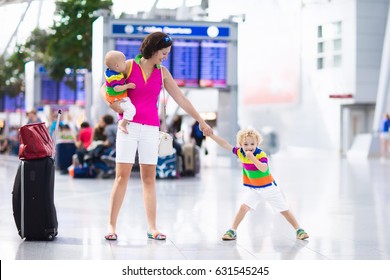 Family At Airport Before Flight. Mother And Kids Waiting To Board At Departure Gate Of Modern International Terminal. Traveling And Flying With Children. Mom With Baby And Toddler Boarding Airplane.