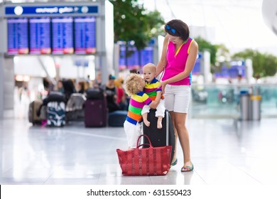 Family At Airport Before Flight. Mother And Kids Waiting To Board At Departure Gate Of Modern International Terminal. Traveling And Flying With Children. Mom With Baby And Toddler Boarding Airplane.