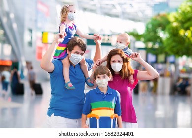 Family in airport in face mask. Virus outbreak. Coronavirus and flu pandemic. Safe travel with young child and baby. Mother, father and kids boarding airplane in surgical masks.