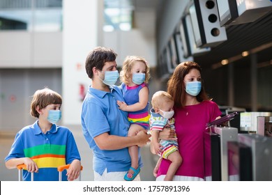 Family In Airport In Face Mask. Virus Outbreak. Coronavirus And Flu Pandemic. Safe Travel With Young Child And Baby. Mother, Father And Kids Boarding Airplane In Surgical Masks.