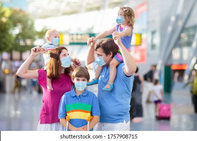 Family In Airport In Face Mask. Virus Outbreak. Coronavirus And Flu Pandemic. Safe Travel With Young Child And Baby. Mother, Father And Kids Boarding Airplane In Surgical Masks.