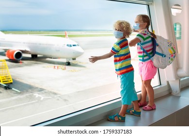 Family In Airport In Face Mask. Virus Outbreak. Coronavirus And Flu Pandemic. Safe Travel With Young Child And Baby. Kids Boarding Airplane In Surgical Masks.