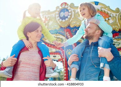 Family In Amusement Park