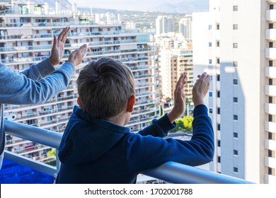 Family Applauding Medical Staff From Balcony. People Clapping On Balconies And Windows In Support Of Health Workers During The Coronavirus Pandemic