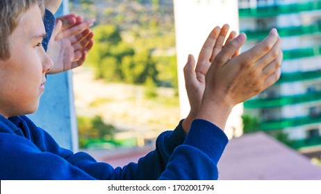 Family Applauding Medical Staff From Balcony. People Clapping On Balconies And Windows In Support Of Health Workers During The Coronavirus Pandemic