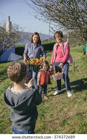 Similar – Image, Stock Photo Boy taking photo to family with apples in basket